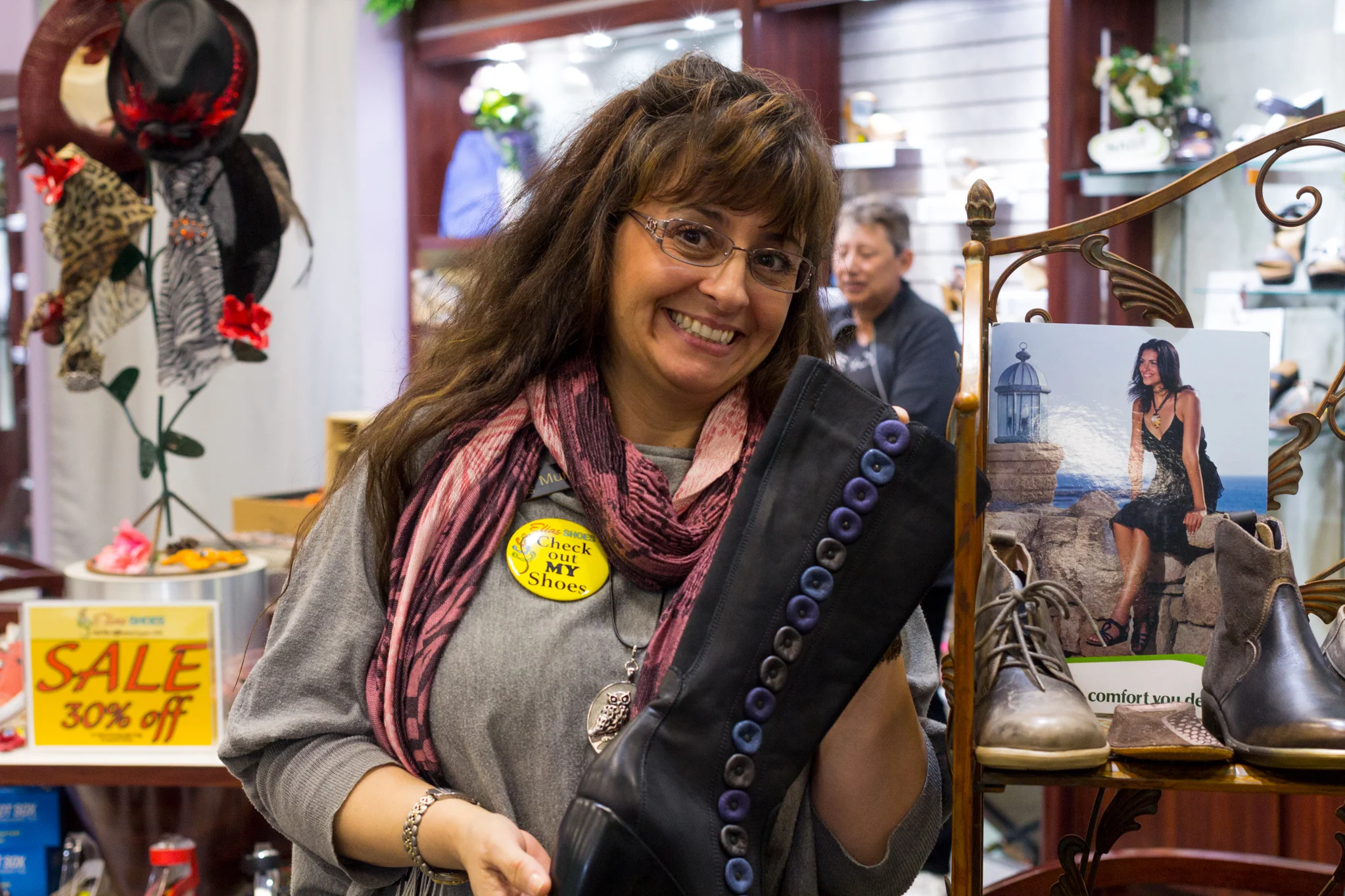 Muna Elias proudly displaying artisan boots inside Elias Shoes